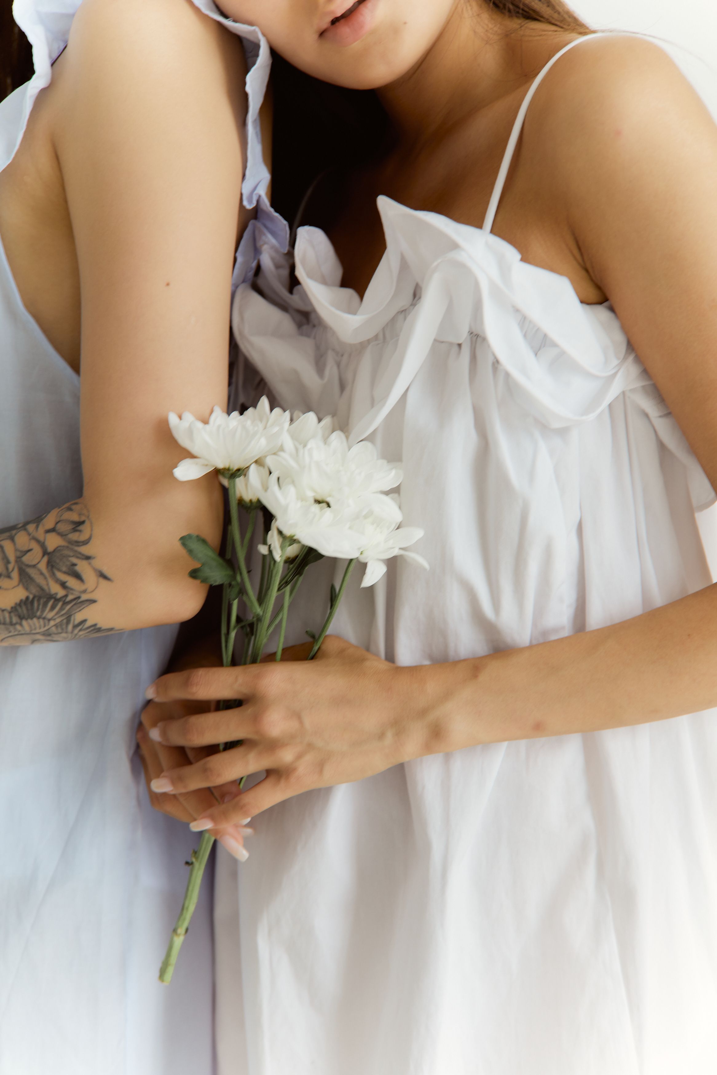 A Woman in White Dress Holding White Flowers · Free Stock Photo