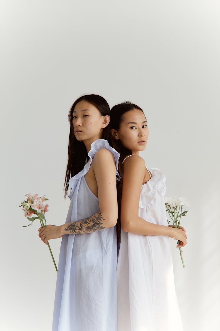 Two Women Holding Flowers