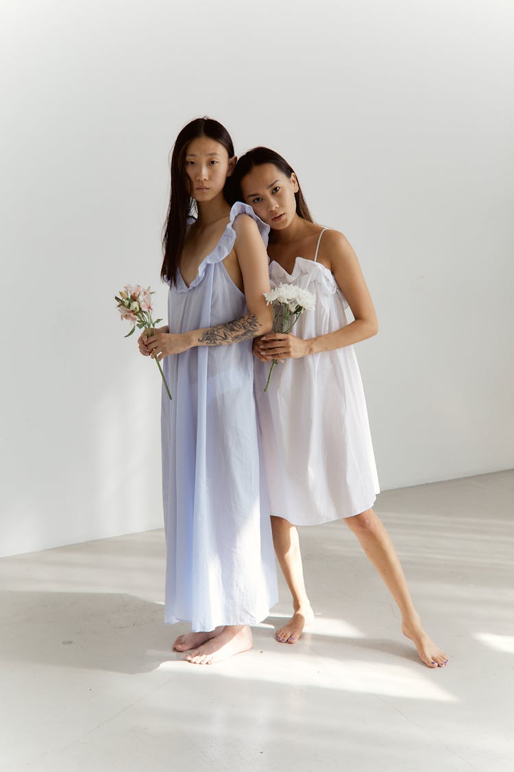 Two Women Holding Flowers