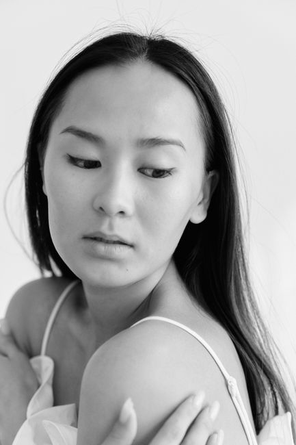 Timeless black and white portrait capturing the elegance and grace of a young woman.