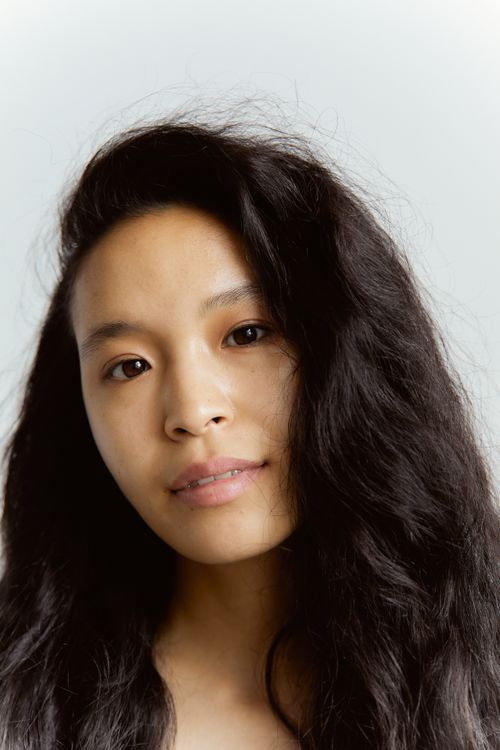 Free Close-up portrait of an east Asian woman with long hair, showcasing natural beauty. Stock Photo