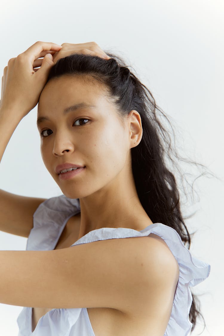 Close-Up Shot Of A Woman Holding Her Hair