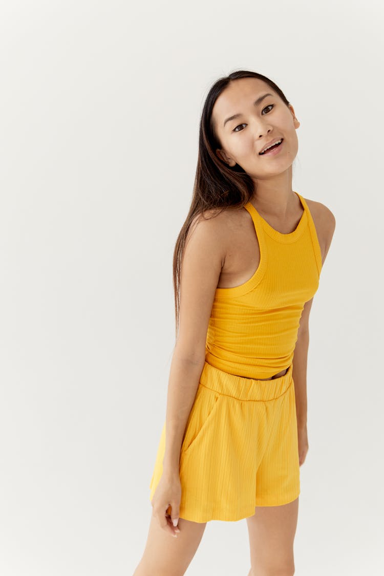 Woman In Yellow Mustard Sleeveless Top And Shorts