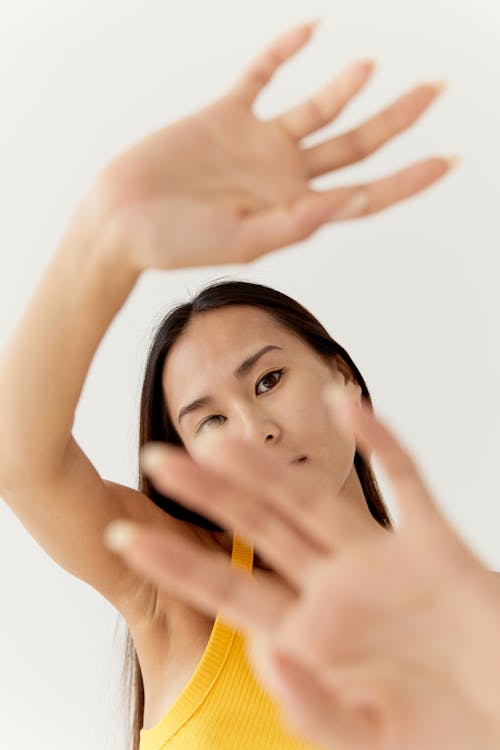 Free A Woman Covering the Camera with Her Hands Stock Photo