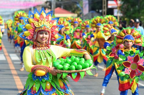 Free Colorful costumes and smiles at the Dinamulag Mango Festival parade in Zambales, Philippines. Stock Photo
