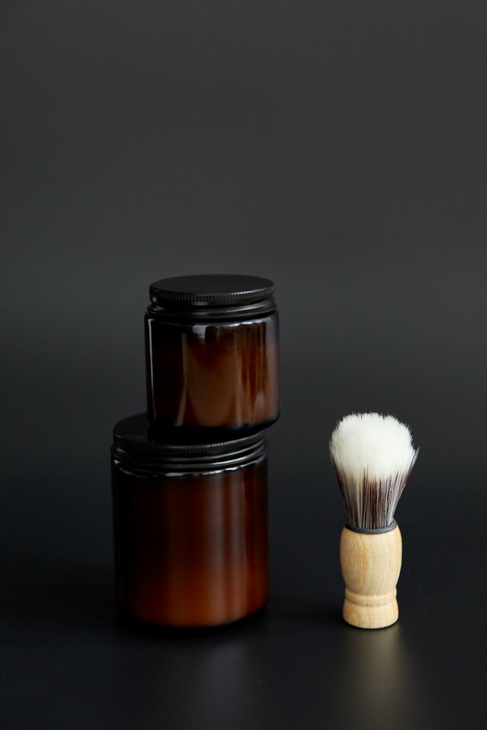 Amber glass grooming jars and a shaving brush