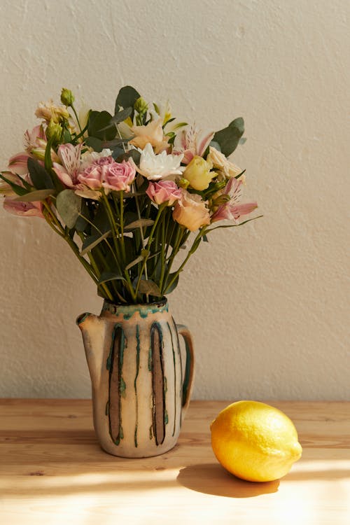  Flowers in the Vase near a Lemon