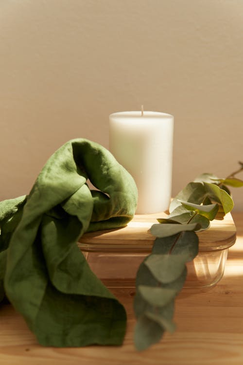 A Candle between a Towel and a Eucalyptus Leaf