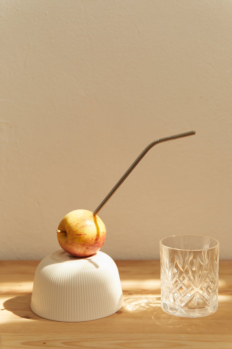 A Metal Straw In An Apple