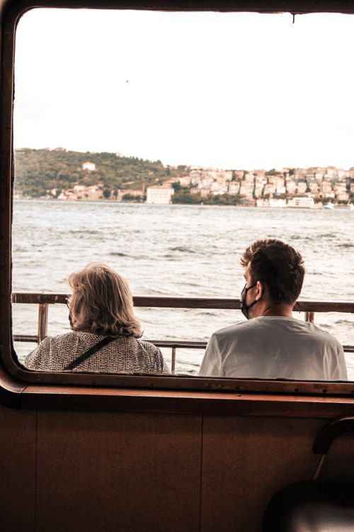 Free Two people enjoying the serene view of Istanbul's Bosphorus from a boat, captured in a candid moment. Stock Photo