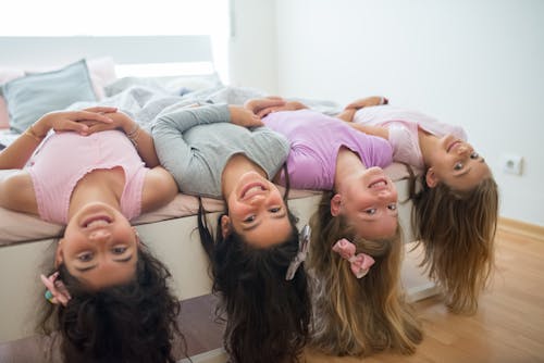 Free Girls Lying on Bed Smiling Stock Photo