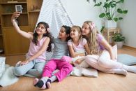 3 Women Sitting on Brown Wooden Floor