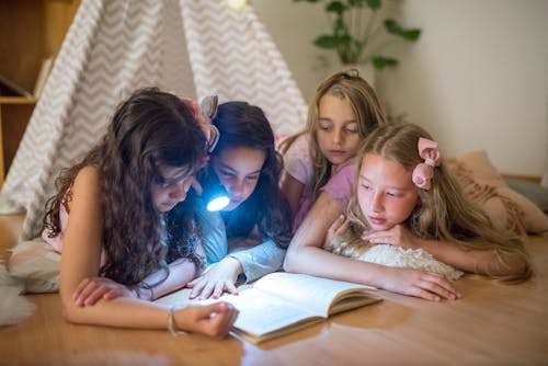 Girls Reading Book Together