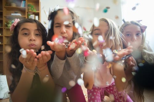 Free Girls in Pajamas Blowing Confetti Stock Photo