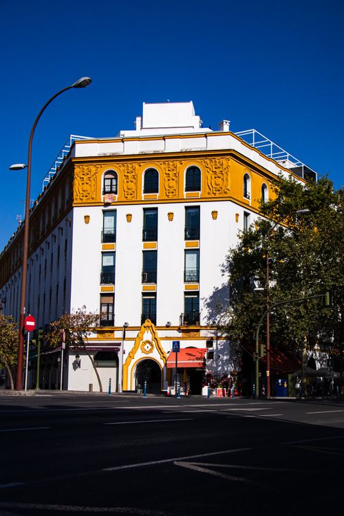 Free Beautiful building in Seville, showcasing unique Spanish architecture under a clear blue sky. Stock Photo