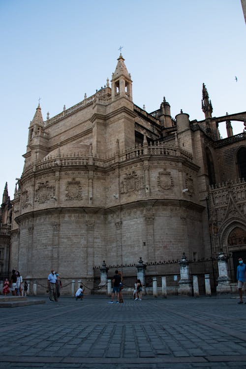 Tourists Under the Walls of Seville Cathedral