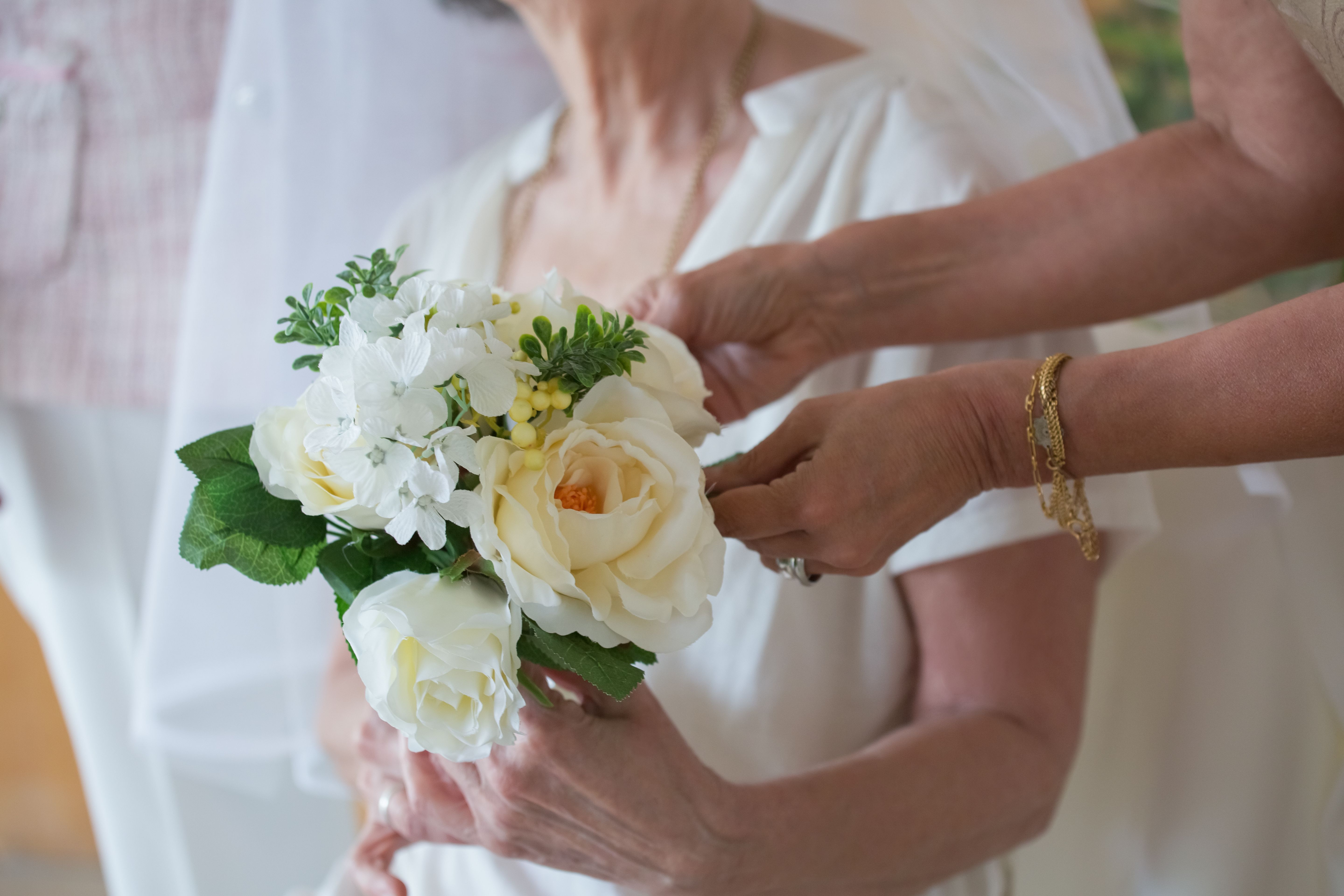 Photo of a Person Holding a Bouquet of Roses · Free Stock Photo