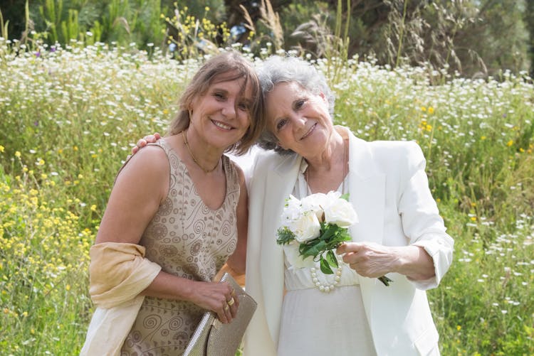 Bride And Bridesmaid On Meadow