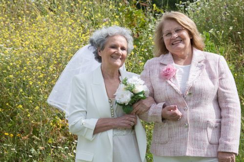 Free A happy senior bride with a friend at an outdoor wedding ceremony. Stock Photo