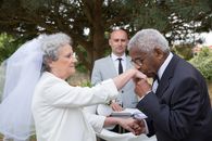 Man in Black Suit Jacket Kissing Woman in White Dress