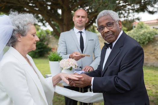 Senior couple exchanging rings at an outdoor wedding ceremony in Portugal.