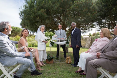Free Wedding Couple Standing Beside the Pastor Stock Photo