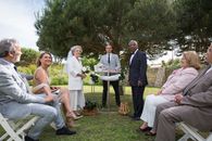 Man in Gray Suit Jacket Sitting Beside Woman in White Dress