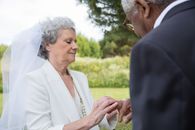 Man in Black Suit Jacket Holding Woman in White Dress