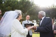 Man in Black Suit Jacket Standing Beside Woman in White Wedding Dress