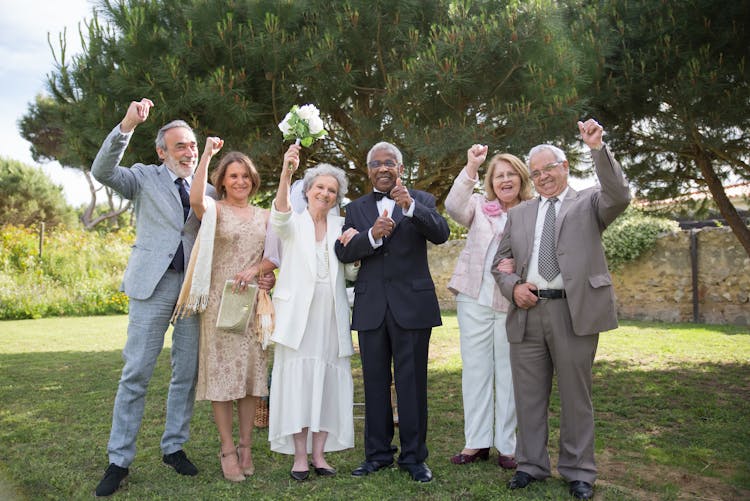 Couple With Their Friends Celebrating Their Wedding