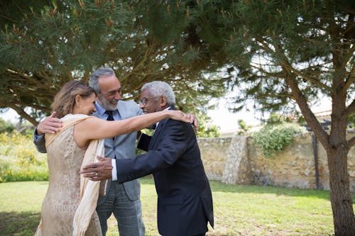 A family laughing and dancing together in a garden setting