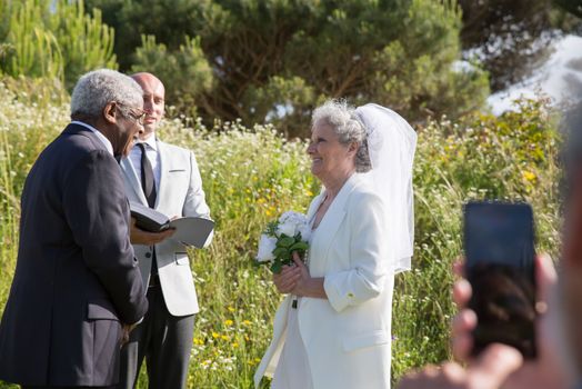 An Elderly Couple Smiling while Looking at Each Other