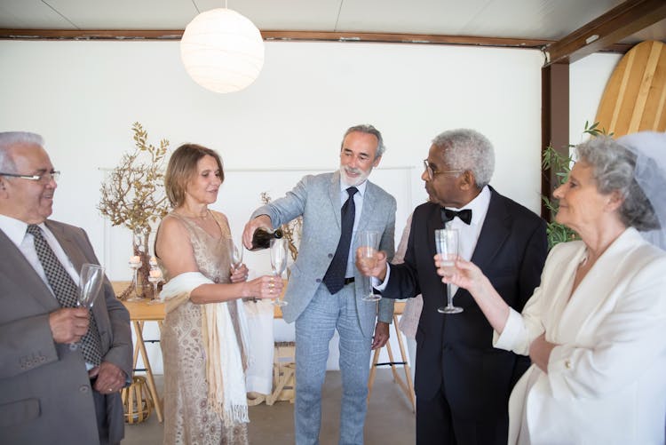 Elderly People Drinking Champagne At A Wedding