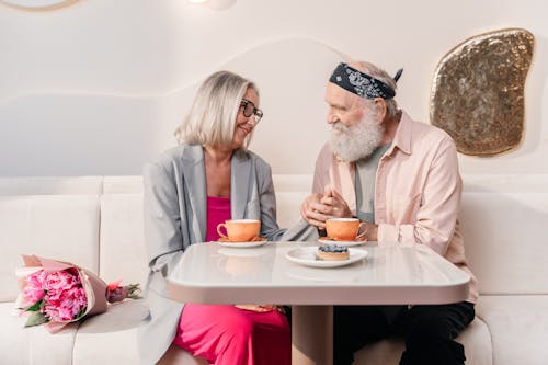 Free Man and Woman Sitting Together Having Coffee Stock Photo