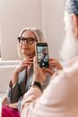 Man Taking a Picture of a Senior Woman