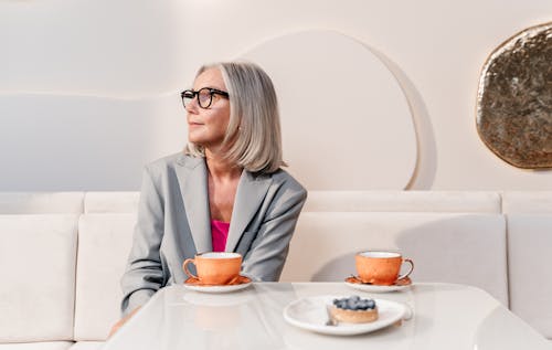 Free Woman Beside Cups of Coffee Stock Photo