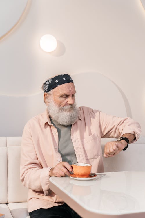 Bearded Man with Black Bandana on his Head Looking at his Wristwatch