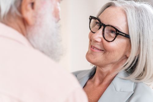 Free A senior couple smiling warmly at each other, highlighting love and companionship in their relationship. Stock Photo