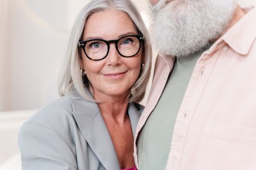 Free Close-up of a smiling senior woman wearing eyeglasses indoors. Stock Photo