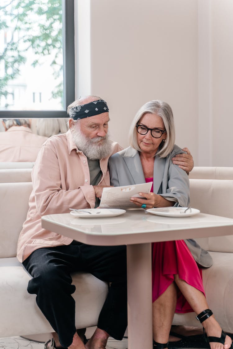 Senior Couple Looking At A Menu In A Cafe