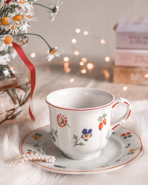 Free White Floral Ceramic Teacup on Saucer Stock Photo