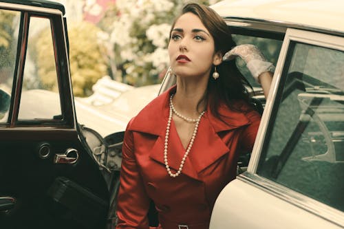 Pretty Woman Posing Beside a Vintage car