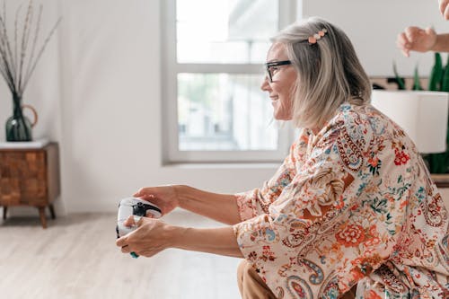 An Elderly Woman Playing a Video Game 