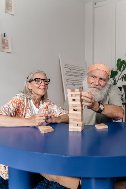 An Elderly Couple Playing with Wooden Blocks