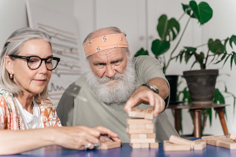 Happy Elderly Couple Playing Jenga Game