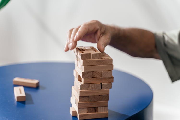 Hand Building Tower On Wooden Blocks 