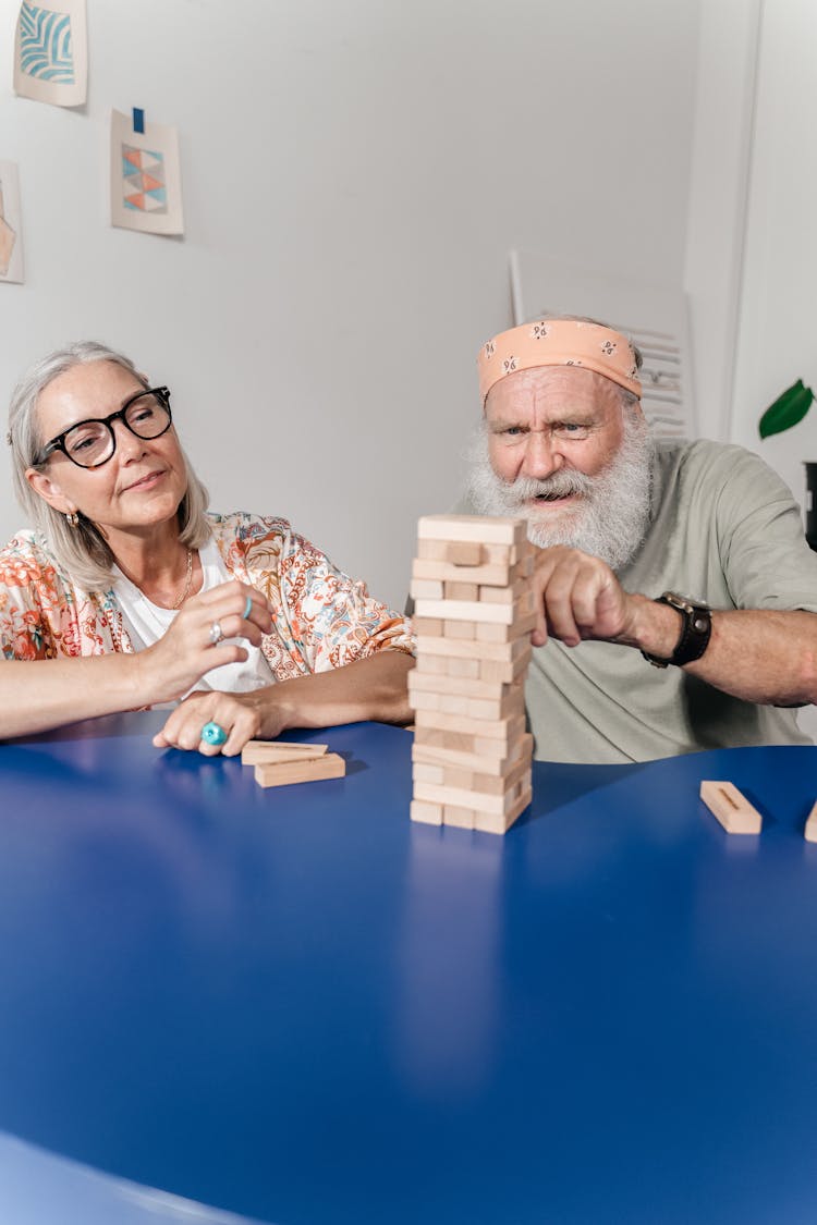 Man And Woman Playing Jenga Together 