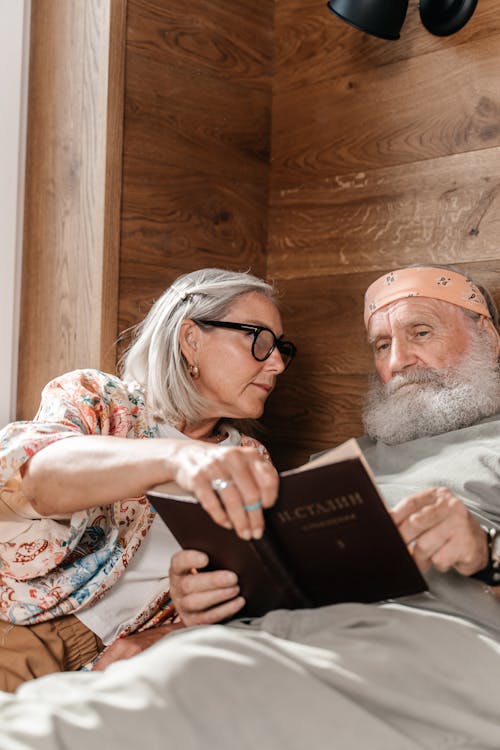 Free Elderly Couple Reading Book Toge Stock Photo