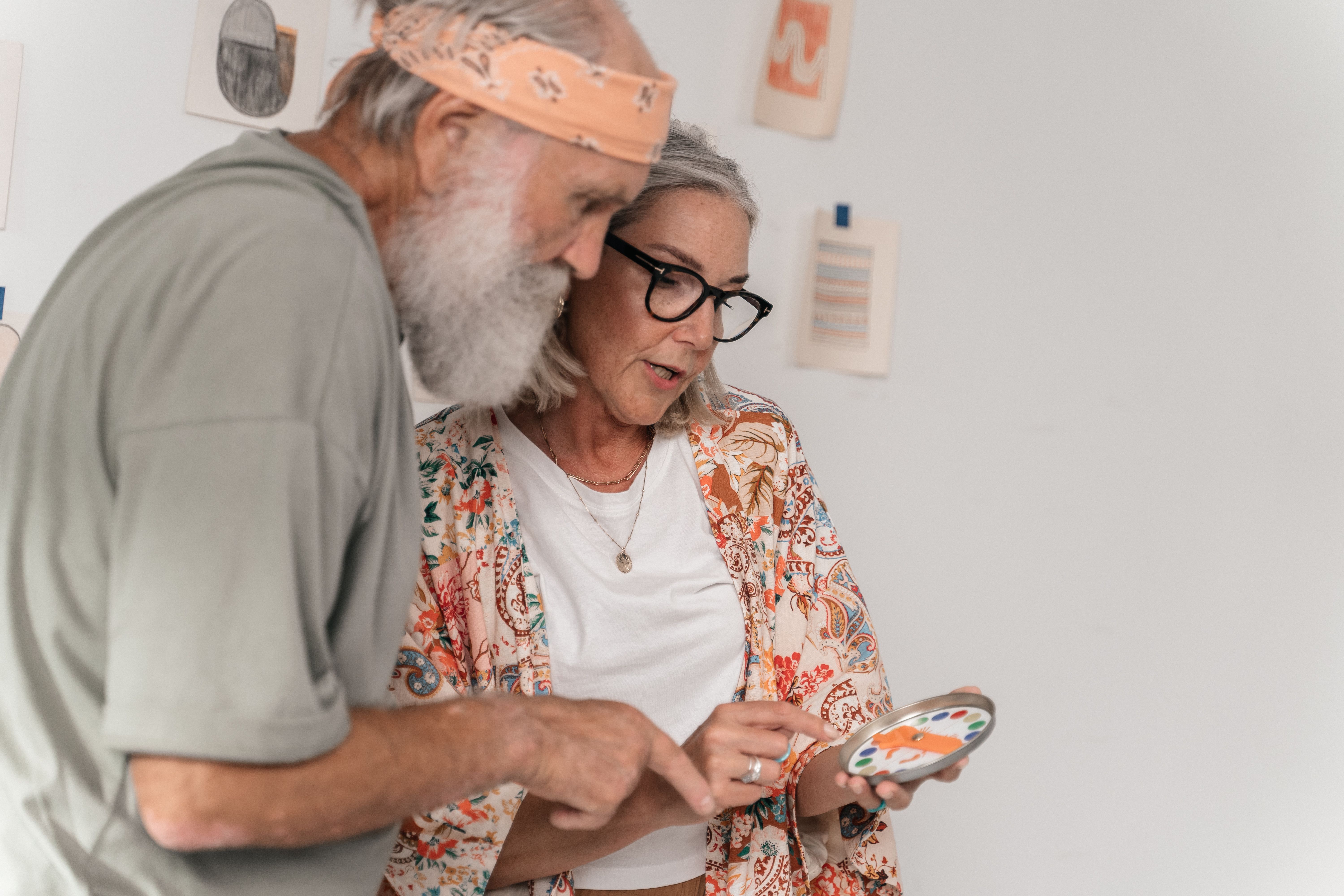 An elderly senior engaging in cognitive activities at home with a caregiver