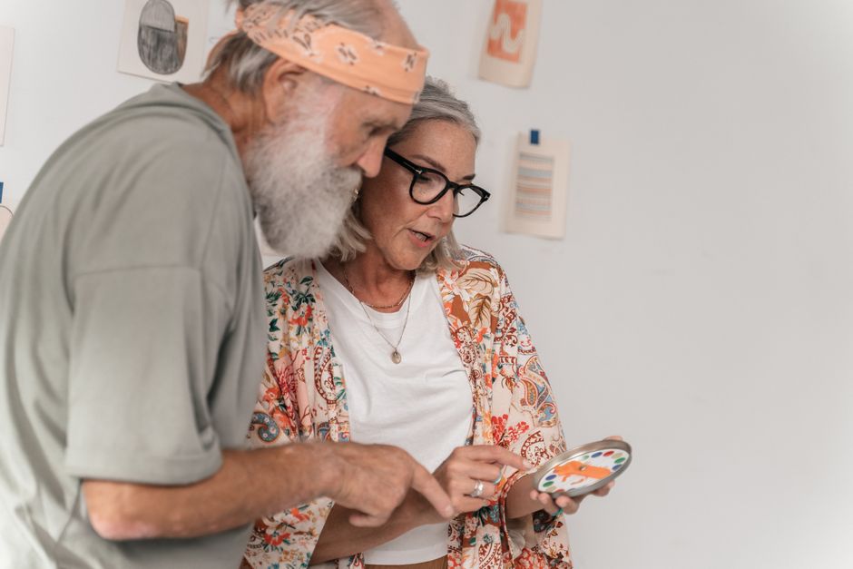 An elderly senior engaging in cognitive activities at home with a caregiver An elderly senior engaging in cognitive activities at home with a caregiver